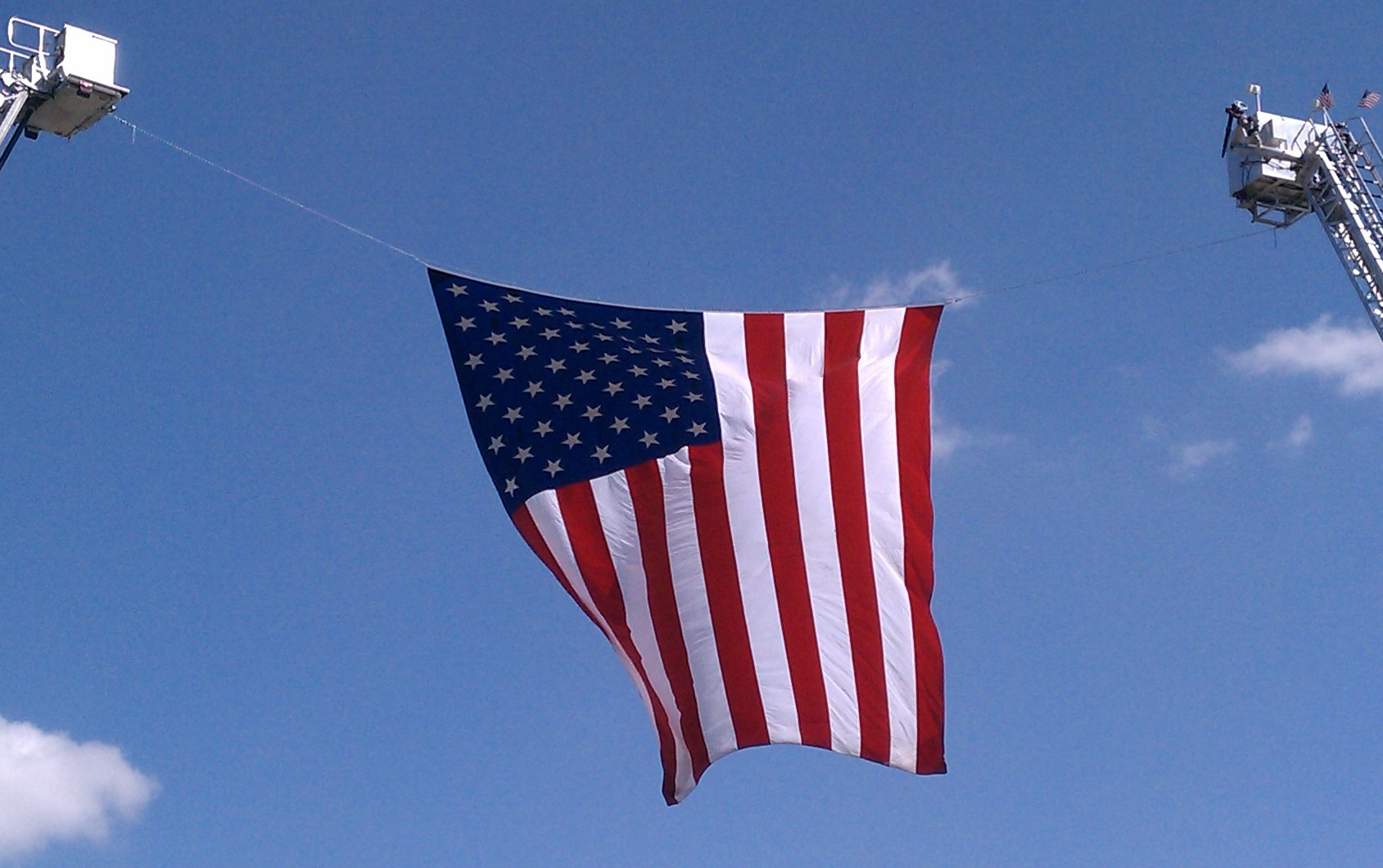 Large flag hanging from cranes displayed at the 9/11 10 year remembrance ceremony in Omaha.