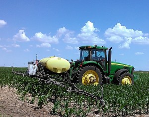 On-farm Research Cooperators, Dennis and Rod Valentine, get ready to spray their corn plots with a sugar/water solution.  Their study is to determine the effect of applying sugar to corn on yield and economics.  